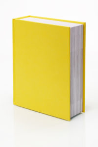 Blank yellow book with real reflection. Clipping path included to place book on any background.